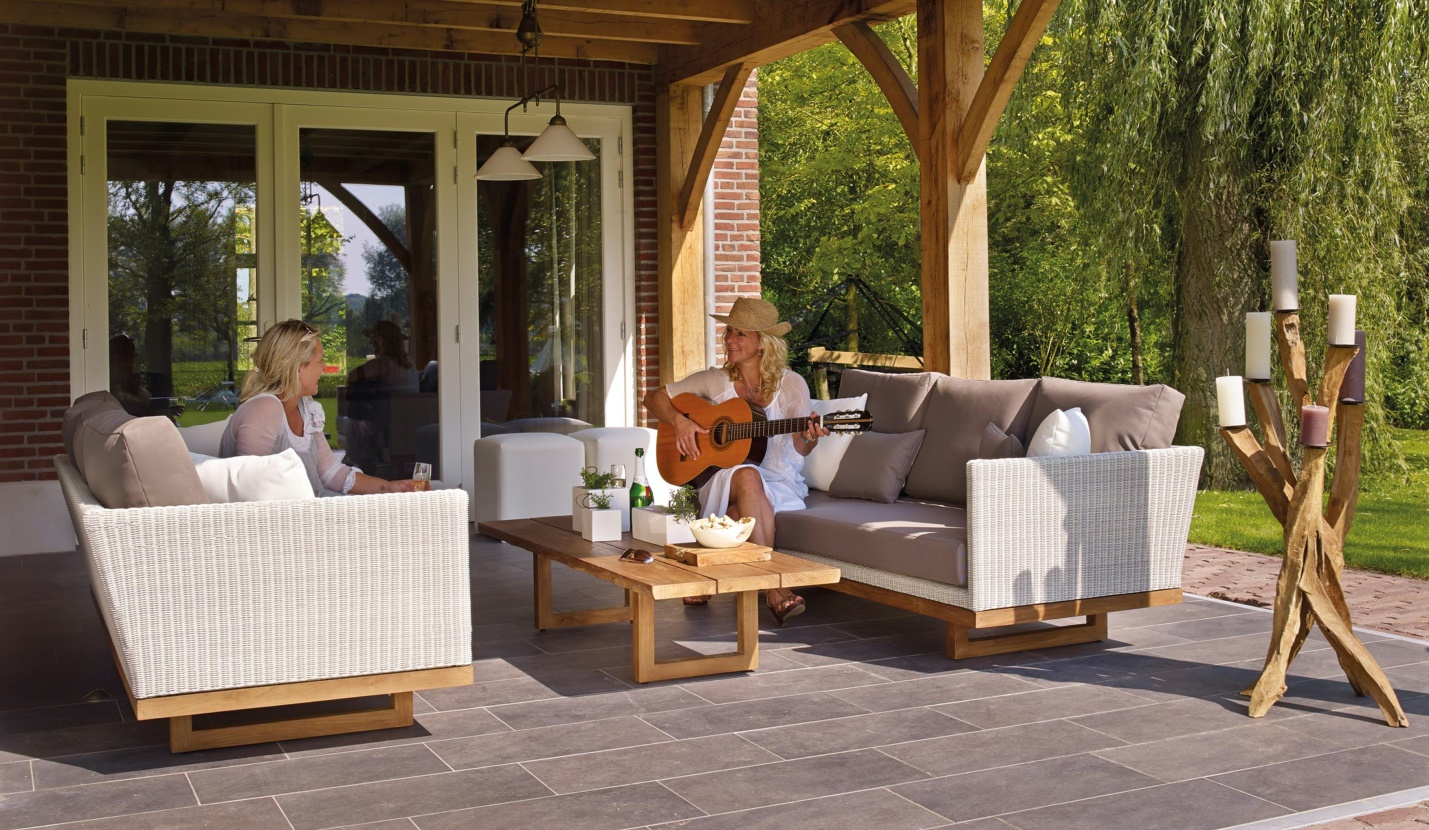 Women enjoying and playing the guitar in the backyard seating