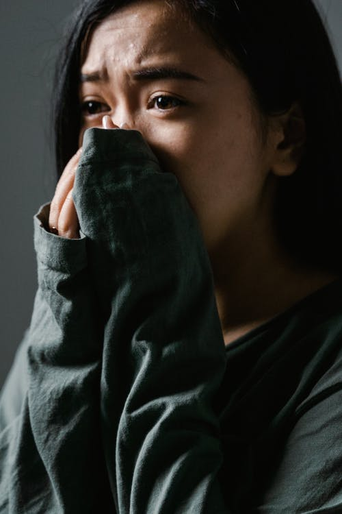 a woman scared of water covering her mouth