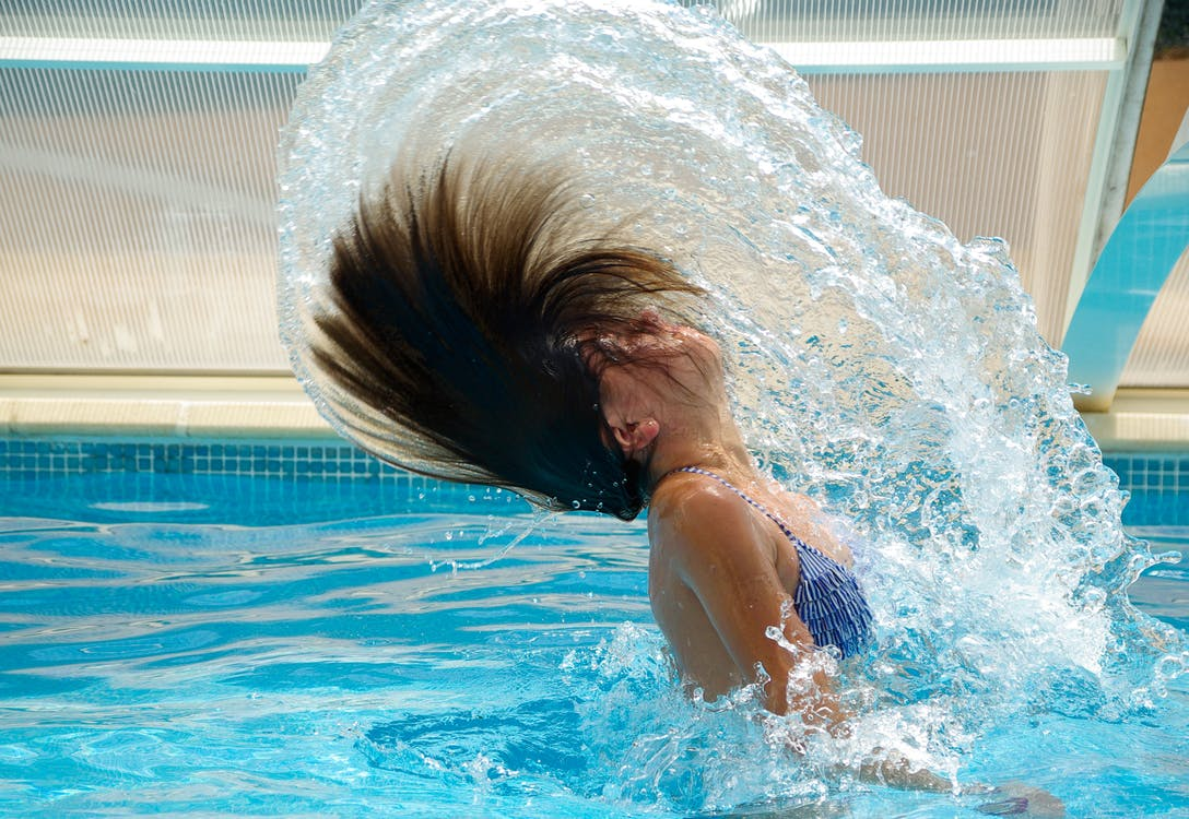 Woman playing with her in the pool