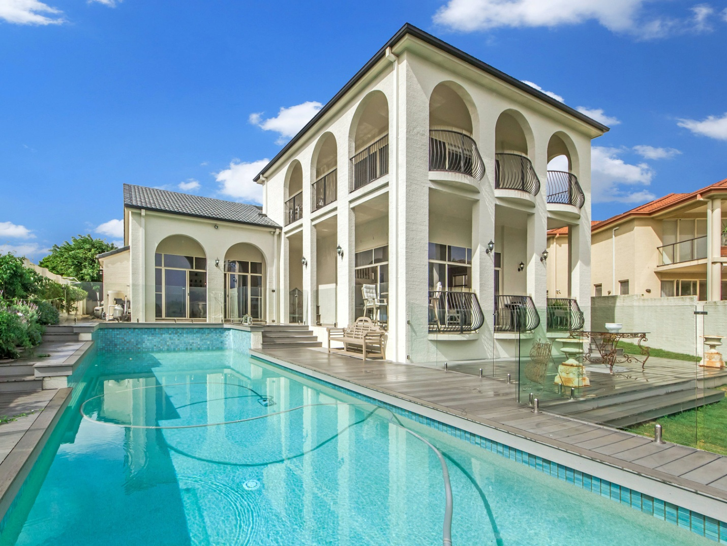 White concrete building with a swimming pool