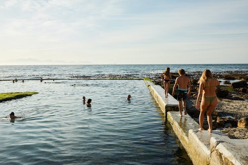 A Picture of a Concrete Pool Next to the Sea