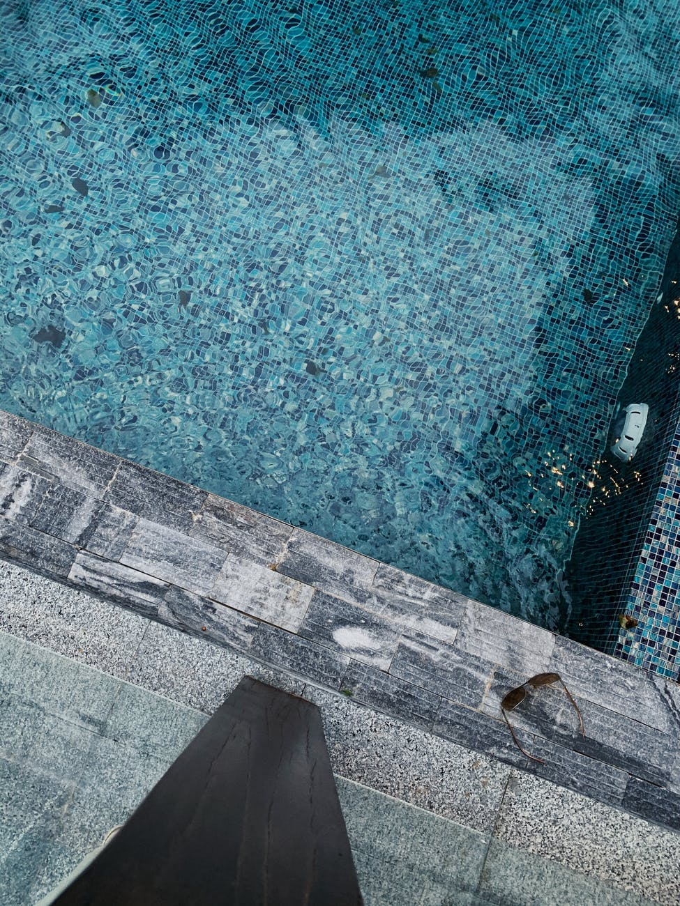 An outdoor pool with multicolored tiles