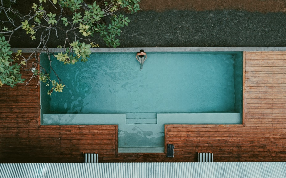 A Person Relaxing In A Swimming Pool