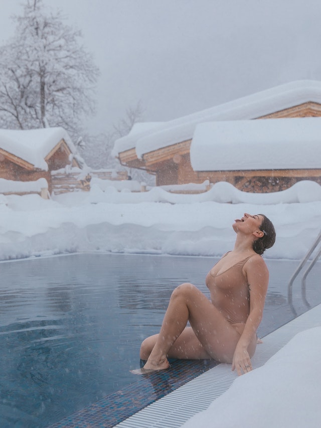 woman sitting in a cold swimming pool