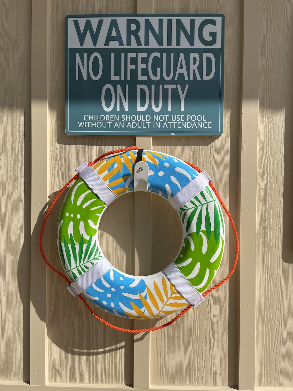  A warning sign reading that children should not be left alone near a pool