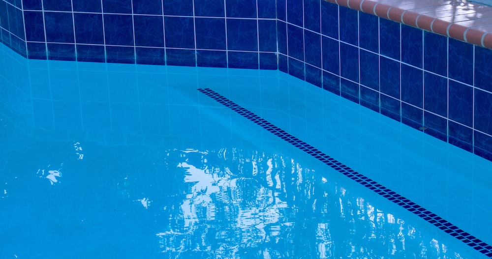 Large pool tiles lining a pool’s floor