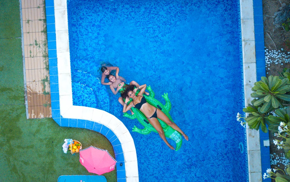 three people swimming in a pool