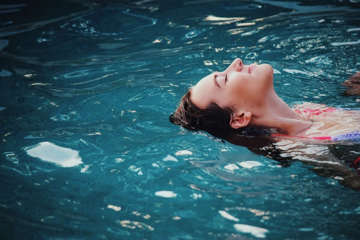 A woman relaxing in a clean swimming pool.