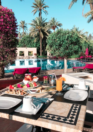 A table with breakfast items placed by the pool