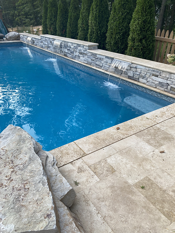 Swimming pool featuring water features 