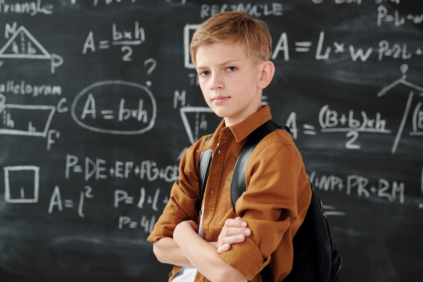 A confident kid in a brown jacket