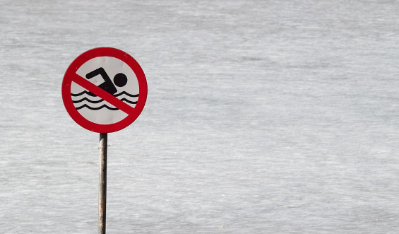  A 'no swimming' sign by a water body