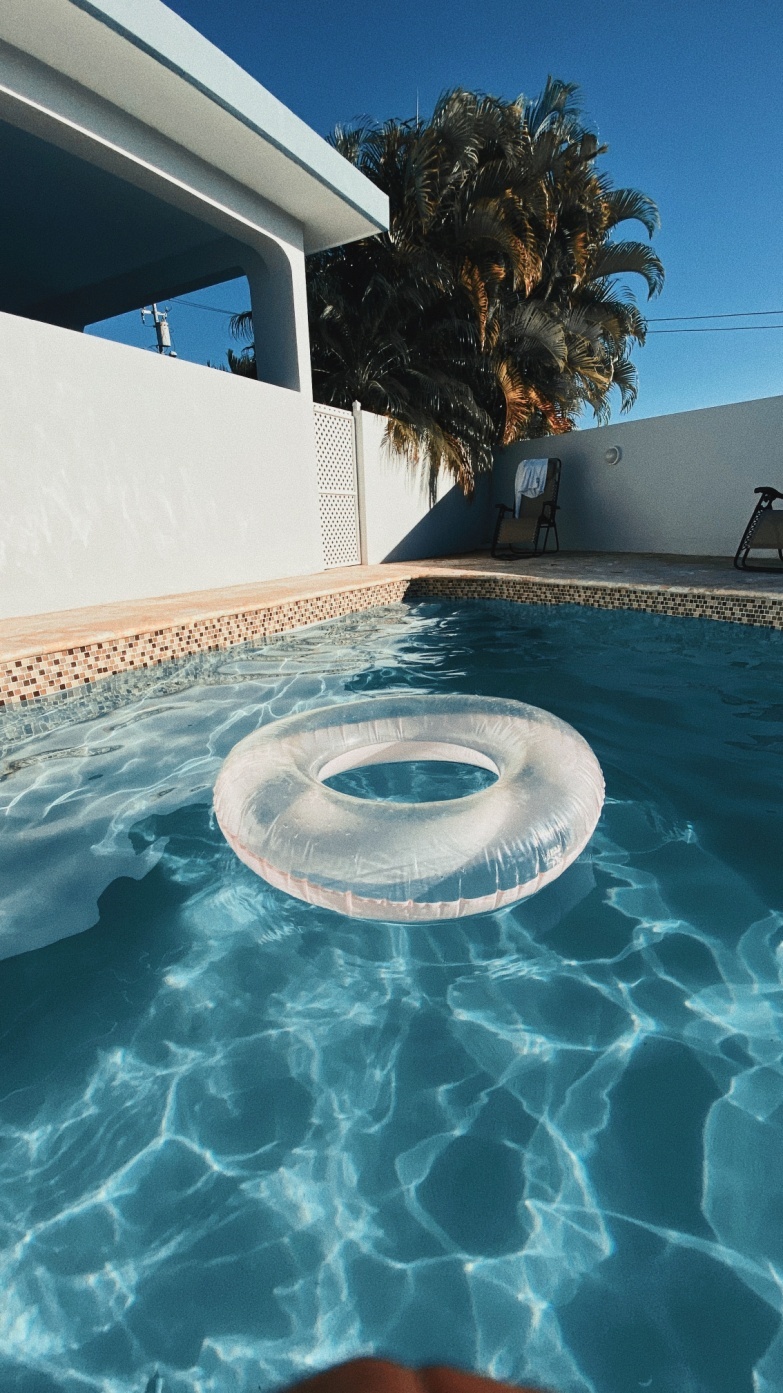 A pool with a swimming tube floating on water