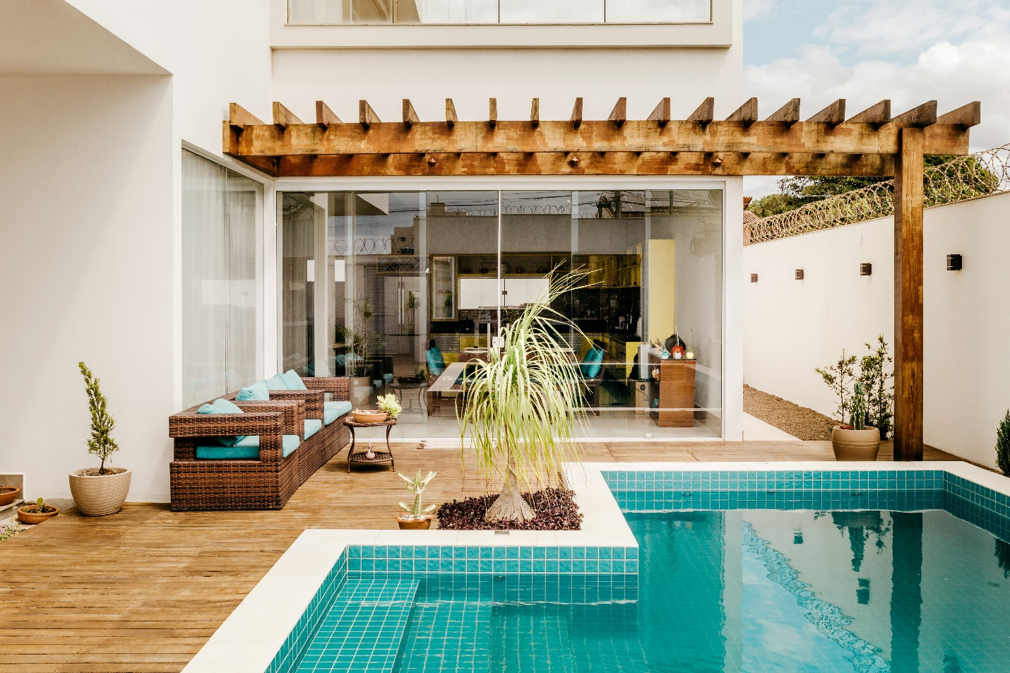 an outdoor pool in a home with glass doors