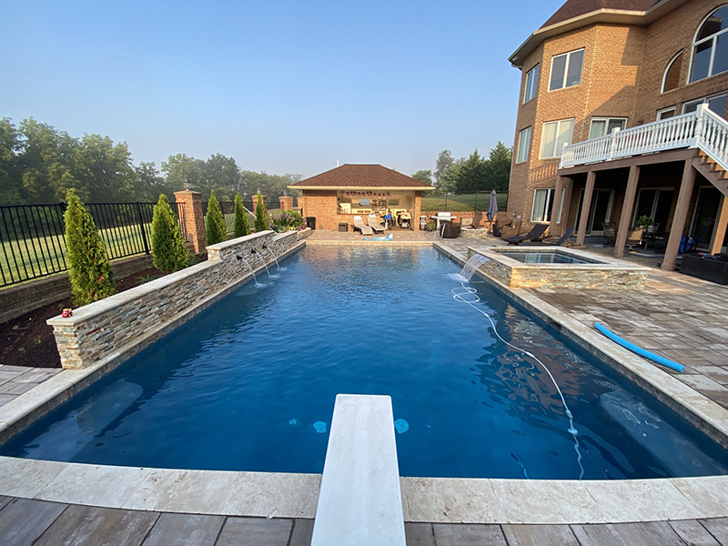 A pool and a hot tub constructed by pool contractors in Sterling