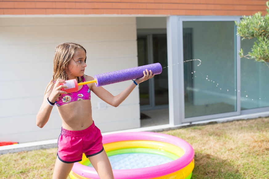 A girl playing with a water gun